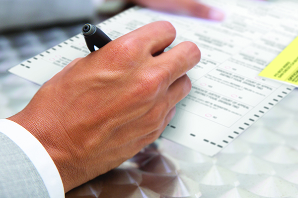 Closeup view of male hand holding pen. African American manager working with documents. Business concept